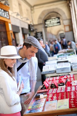 Tourists in Madrid walking by flea market