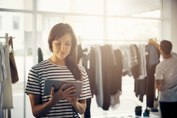 Shot of a boutique owner using a digital tablet with a customer blurred in the backgroundhttp://195.154.178.81/DATA/i_collage/pu/shoots/806285.jpg